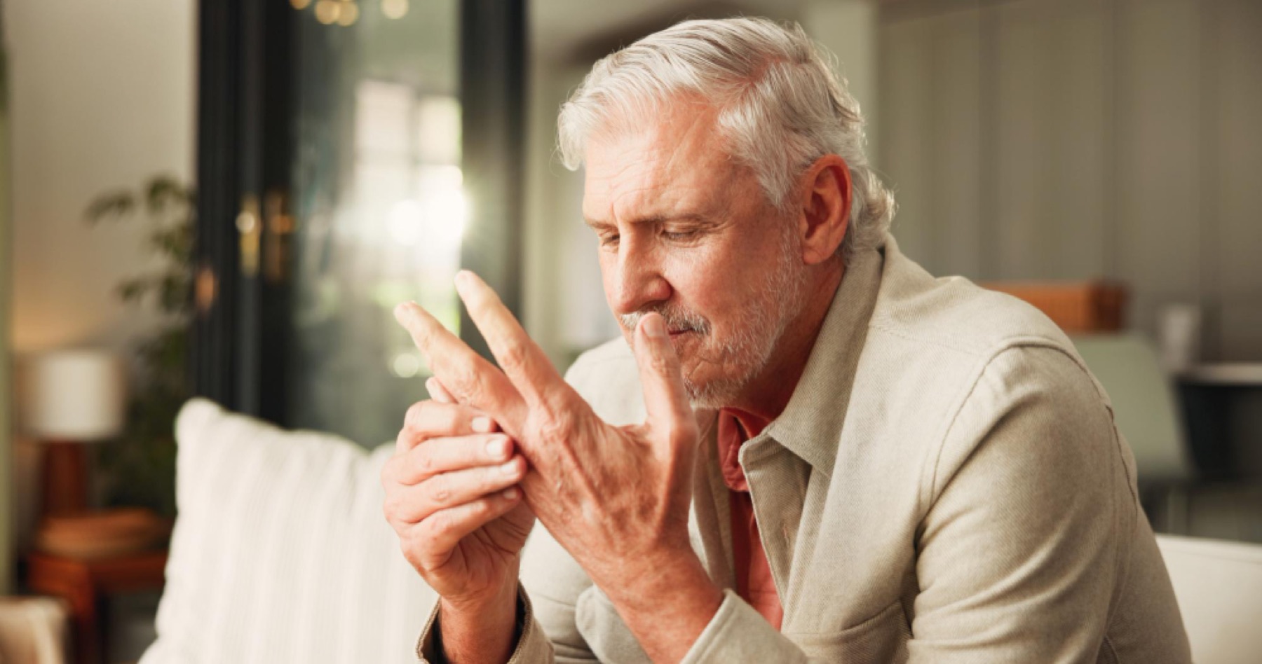 Mature man carefully using a mobile phone